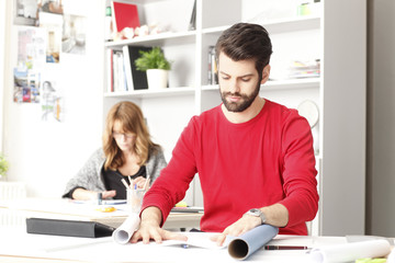 Young architect working in studio.