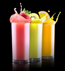 tasty summer fruits with juice in glass