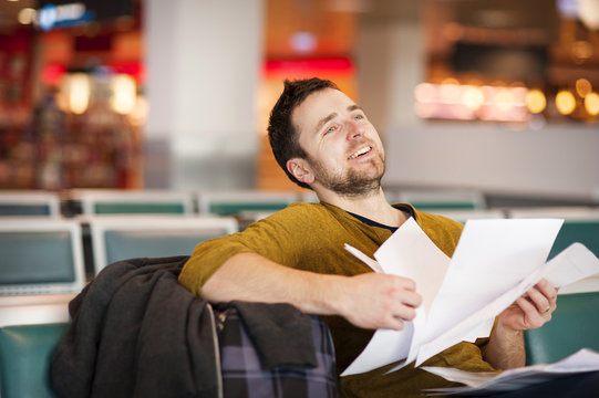 Young man at the airport is going for holiday