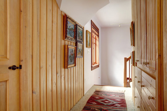 Narrow wood plank paneled hallway