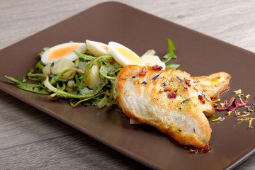 Grilled chicken fillet and dandelions with egg