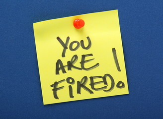 You Are Fired Yellow Sticky Note on a Notice Board