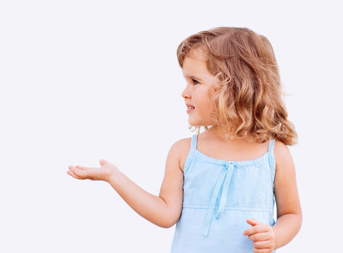 Curly Little Girl Holding Her Hand Out And Showing Copy Space