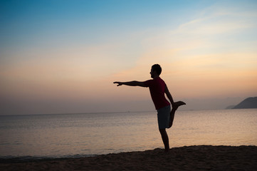 Fototapeta na wymiar Silhouette of runner on the beach at sunset