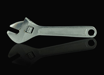 Closed up Adjustable Wrench isolated on black background