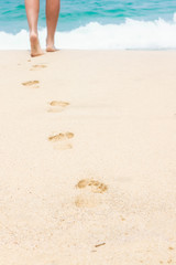 Human footprints on the white sandy beach