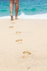 Human footprints on the white sandy beach