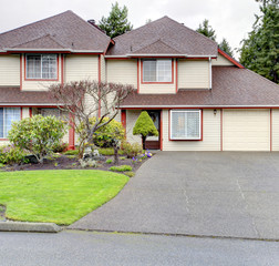 Fototapeta na wymiar Big house with garage. Siding exterior with red corner trim