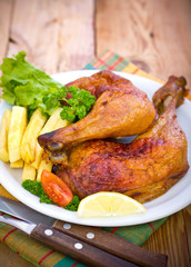 Roasted chicken legs on the plate