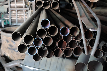 Stack of iron pipes, spar parts.