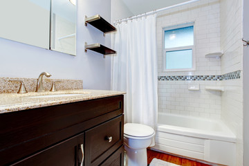 View of the bathroom washbasin cabinet and tub