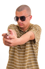 Fototapeta premium handsome young man pointing with toy gun against a white backgro