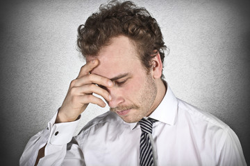 Worried businessman with hand on the head