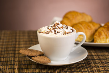 Coffee with whipped cream and croissant, donuts
