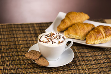 Coffee with whipped cream and croissant, donuts