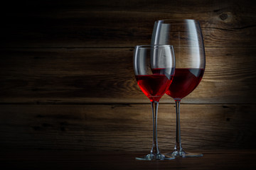 glasses of wine on a wooden background