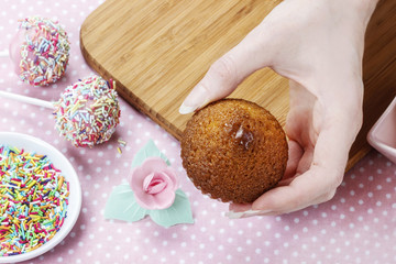 Woman decorating muffins