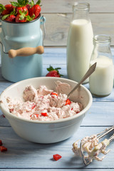 Whipped cream and fresh strawberries as ingredients for ice crea