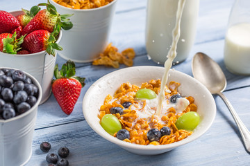 Cornflakes with fruits flooded with milk