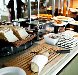 Assortment of fresh pastry on table in buffet with toaster