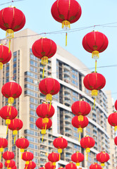Fototapeta na wymiar red lanterns hang in modern city to celebrate chinese festival