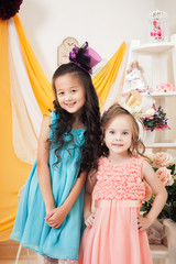 Two well-dressed girls posing looking at camera