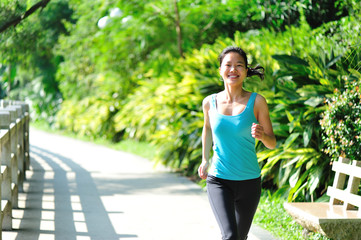 fitness woman running at trail in park