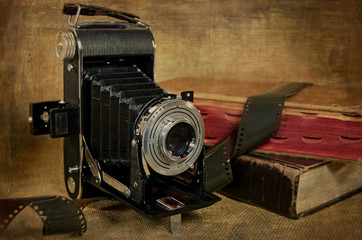 bellows camera with film and books