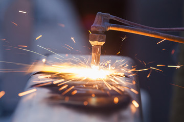 worker cutting steel pipe using metal torch and install roadside