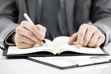 business report and man hand with pen