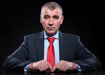 mature business man sitting at his desk