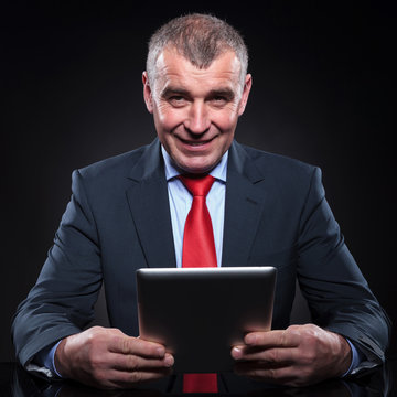 Old Business Man Working On His Tablet Pad Computer