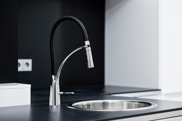 Modern stylish faucet in the black and white design kitchen - obrazy, fototapety, plakaty