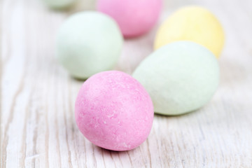 marcipan eggs on white wooden surface