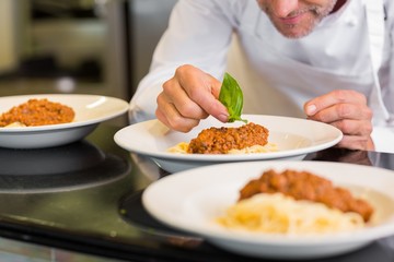 Closeup of a male chef garnishing food