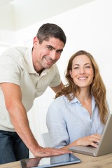 Confident couple using laptop