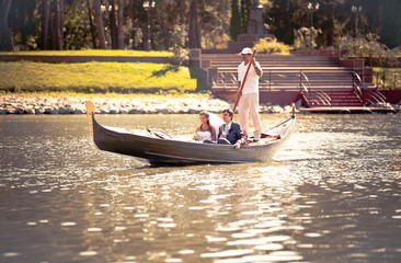Newly married couple riding on gondola on river © Kyrylo Ryzhov