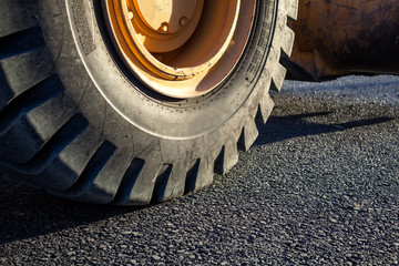 Close-up excavator tire in the road