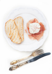 Poached eggs with parma ham prosciutto and ciabatta