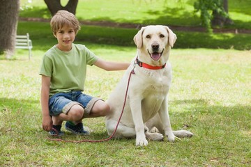 Full length of a boy with pet dog at park