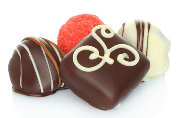 Assorted chocolate candies on white background