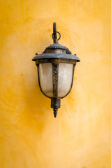 Lantern on a yellow wall