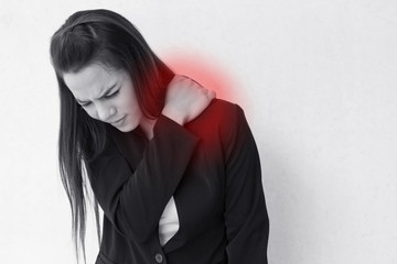 heavy shoulder pain or stiffness of business woman