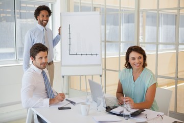 Businessman giving presentation to colleagues in office