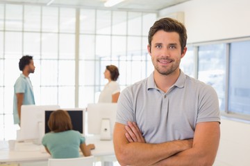 Obraz premium Portrait of a smiling businessman with colleagues in meeting