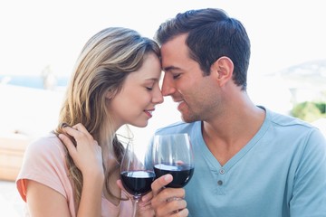Loving young couple toasting wine glasses