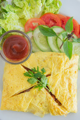 stuffed omelette with salad and ketchup