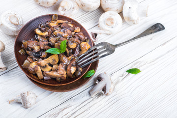 Fresh champignons on a wooden board