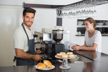 Male cafe owner with woman at the coffee shop