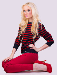 Fototapeta premium Beautiful fashionable blonde girl in sweater